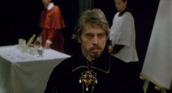 Movie still from “Caravaggio” (1986), directed by Derek Jarman – A person wearing a costume; Close Up shot, Over the shoulder angle