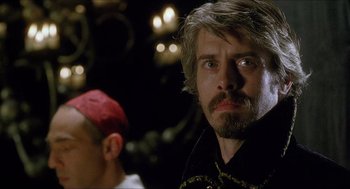 Movie still from “Caravaggio” (1986), directed by Derek Jarman – A person with a beard; Close Up shot, Over the shoulder angle