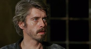 Movie still from “Caravaggio” (1986), directed by Derek Jarman – A person with long hair and a beard; Close Up shot, Over the shoulder angle