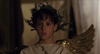 Movie still from “Caravaggio” (1986), directed by Derek Jarman – A young boy wearing a crown of flowers; Close Up shot, Over the shoulder angle