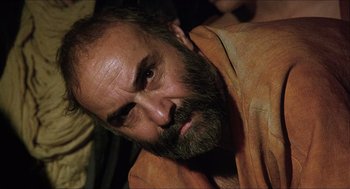 Movie still from “Caravaggio” (1986), directed by Derek Jarman – A person with a beard; Close Up shot, Over the shoulder angle