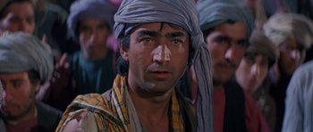 Movie still from “Caravans” (1978), directed by James Fargo – A person wearing a turban; Close Up shot, Over the shoulder angle