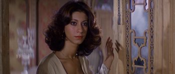 Movie still from “Caravans” (1978), directed by James Fargo – A beautiful woman with long brown curly hair; Close Up shot, Low angle