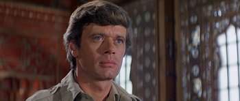 Movie still from “Caravans” (1978), directed by James Fargo – A person wearing a shirt; Close Up shot, Low angle