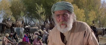 Movie still from “Caravans” (1978), directed by James Fargo – An old man with a beard wearing a blue turban; Close Up shot, Low angle