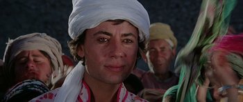Movie still from “Caravans” (1978), directed by James Fargo – A person wearing a turban; Close Up shot, Low angle