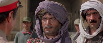 Movie still from “Caravans” (1978), directed by James Fargo – A person wearing a turban; Close Up shot, Low angle