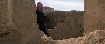 Movie still from “Caravans” (1978), directed by James Fargo – A woman standing in the middle of a desert; Wide shot, Low angle
