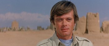 Movie still from “Caravans” (1978), directed by James Fargo – A person wearing a shirt; Close Up shot, Low angle