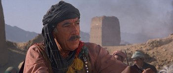 Movie still from “Caravans” (1978), directed by James Fargo – An older man with a mustache and a turban; Close Up shot, Low angle