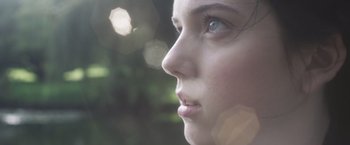 Movie still from “Carmilla” (2019), directed by Emily Harris – A young woman's face; Extreme Close Up shot, Low angle