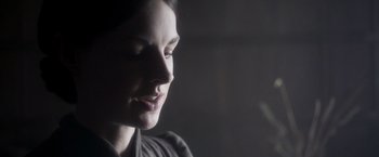 Movie still from “Carmilla” (2019), directed by Emily Harris – A woman's face in the dark; Close Up shot, Over the shoulder angle