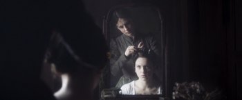 Movie still from “Carmilla” (2019), directed by Emily Harris – A woman getting her hair done in a mirror; Close Up shot, Over the shoulder angle
