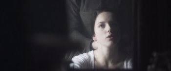 Movie still from “Carmilla” (2019), directed by Emily Harris – A woman sitting in a chair with her eyes closed; Close Up shot, Over the shoulder angle