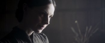 Movie still from “Carmilla” (2019), directed by Emily Harris – A woman's face in a dark room; Close Up shot, Over the shoulder angle