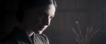 Movie still from “Carmilla” (2019), directed by Emily Harris – A woman's face in the dark; Close Up shot, Over the shoulder angle