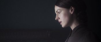 Movie still from “Carmilla” (2019), directed by Emily Harris – A person looking to the side; Close Up shot, Over the shoulder angle