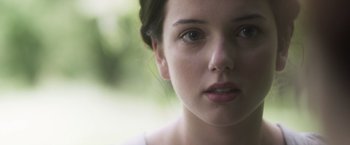 Movie still from “Carmilla” (2019), directed by Emily Harris – A young woman's face; Close Up shot, Over the shoulder angle