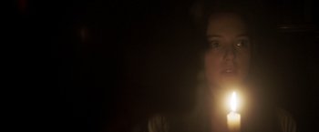 Movie still from “Carmilla” (2019), directed by Emily Harris – A woman with a light in her mouth; Close Up shot, Low angle
