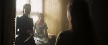 Movie still from “Carmilla” (2019), directed by Emily Harris – A woman sitting in front of a mirror in front of a window; Medium shot, Over the shoulder angle