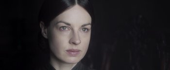 Movie still from “Carmilla” (2019), directed by Emily Harris – A person wearing a black shirt; Close Up shot, Over the shoulder angle