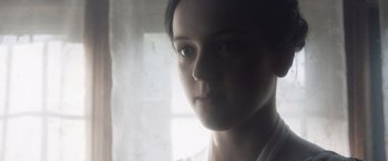Movie still from “Carmilla” (2019), directed by Emily Harris – A person looking out a window; Close Up shot, Low angle