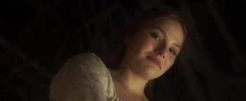 Movie still from “Carmilla” (2019), directed by Emily Harris – A young woman with long brown hair wearing a white shirt; Close Up shot, Low angle