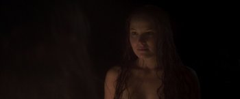 Movie still from “Carmilla” (2019), directed by Emily Harris – A woman with long hair is standing in the dark; Close Up shot, Over the shoulder angle