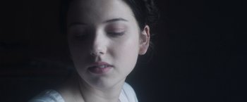 Movie still from “Carmilla” (2019), directed by Emily Harris – A person with closed eyes; Close Up shot, Over the shoulder angle