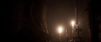 Movie still from “Carmilla” (2019), directed by Emily Harris – A candle in the middle of the room; Medium shot, Low angle