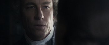 Movie still from “Carmilla” (2019), directed by Emily Harris – A man's face in the dark; Close Up shot, Over the shoulder angle