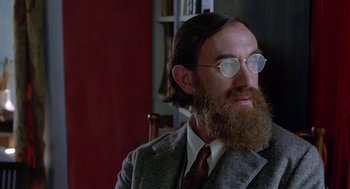 Movie still from “Carrington” (1995), directed by Christopher Hampton – A man with a long beard wearing a suit; Close Up shot, Low angle