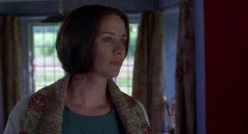 Movie still from “Carrington” (1995), directed by Christopher Hampton – A beautiful woman with long brown hair wearing a green shirt; Close Up shot, Over the shoulder angle