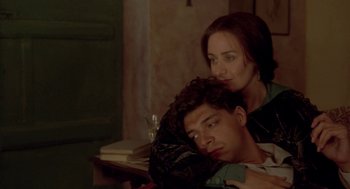 Movie still from “Carrington” (1995), directed by Christopher Hampton – A man and a woman sitting next to each other in a room; Medium shot, High angle