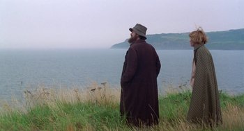 Movie still from “Carrington” (1995), directed by Christopher Hampton – A man standing in the grass looking out at the water; Wide shot, Low angle