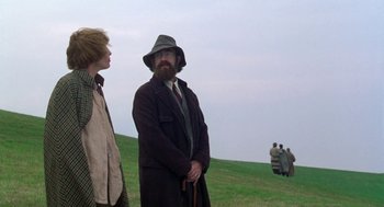 Movie still from “Carrington” (1995), directed by Christopher Hampton – A man and a woman standing in a field; Medium shot, Over the shoulder angle