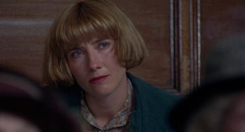 Movie still from “Carrington” (1995), directed by Christopher Hampton – A person with short blonde hair; Close Up shot, Over the shoulder angle