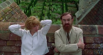 Movie still from “Carrington” (1995), directed by Christopher Hampton – A man and a woman sitting next to each other; Medium shot, High angle