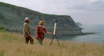 Movie still from “Carrington” (1995), directed by Christopher Hampton – A man and a woman are painting on a field; Wide shot, Low angle