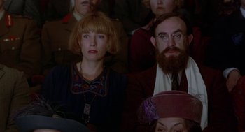 Movie still from “Carrington” (1995), directed by Christopher Hampton – A group of people sitting in a room; Close Up shot, High angle