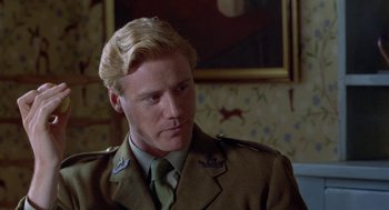 Movie still from “Carrington” (1995), directed by Christopher Hampton – A person wearing a uniform; Close Up shot, Over the shoulder angle