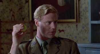 Movie still from “Carrington” (1995), directed by Christopher Hampton – A person holding an apple; Close Up shot, Over the shoulder angle