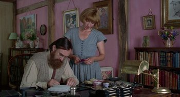 Movie still from “Carrington” (1995), directed by Christopher Hampton – A man and a woman working together on a project; Medium shot, Low angle