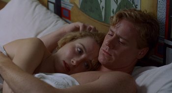 Movie still from “Carrington” (1995), directed by Christopher Hampton – A man and a woman laying in a bed together; Close Up shot, Overhead angle