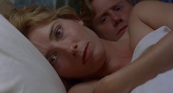 Movie still from “Carrington” (1995), directed by Christopher Hampton – A woman laying in bed next to a man; Close Up shot, Low angle