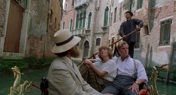 Movie still from “Carrington” (1995), directed by Christopher Hampton – A group of people sitting on a boat in the water; Wide shot, Low angle