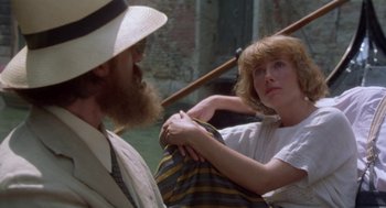Movie still from “Carrington” (1995), directed by Christopher Hampton – A man and a woman are holding a bag together; Medium shot, Over the shoulder angle