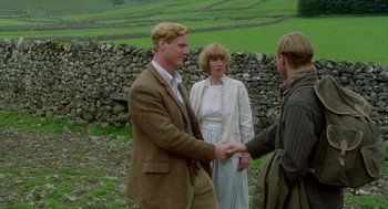 Movie still from “Carrington” (1995), directed by Christopher Hampton – A man and two women shaking hands in a field; Medium shot, Over the shoulder angle
