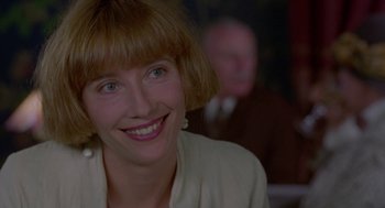 Movie still from “Carrington” (1995), directed by Christopher Hampton – A person with a smile on their face; Close Up shot, Over the shoulder angle