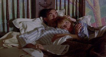 Movie still from “Carrington” (1995), directed by Christopher Hampton – A man and a woman laying in a bed together; Medium shot, High angle